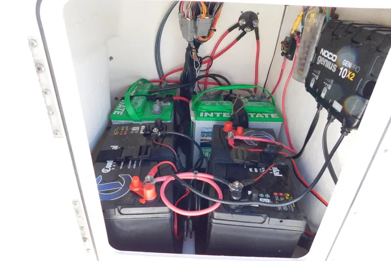 Slide: The Image of 2019 Key West 1720 Center Console boat battery compartment with wiring and charger. - 13