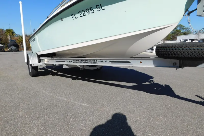 Slide: The Image of 2019 Key West 1720 Center Console boat on trailer, parked outdoors. - 25