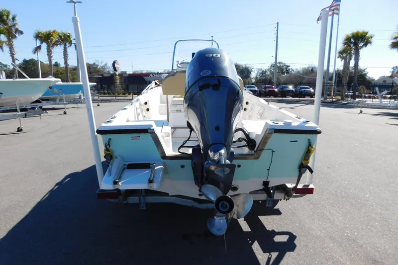Slide: The Image of 2019 Key West 1720 Center Console boat with outboard motor, parked outdoors. - 3