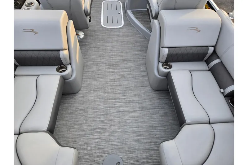 Slide: The Image of 2021 Bennington L 22 Quad Bench interior with gray seating and cup holders. - 17