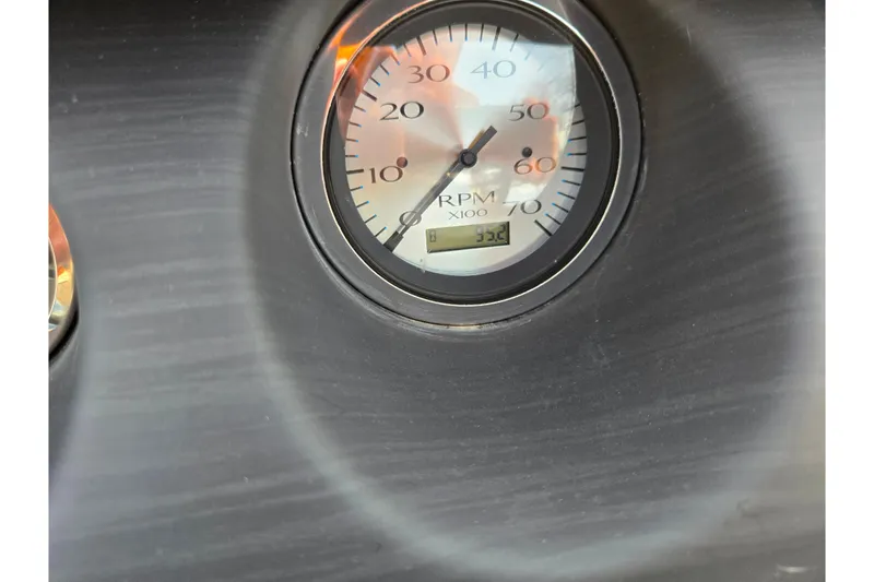 Slide: The Image of RPM gauge on 2021 Bennington L 22 Quad Bench dashboard, displaying 33.2. - 20