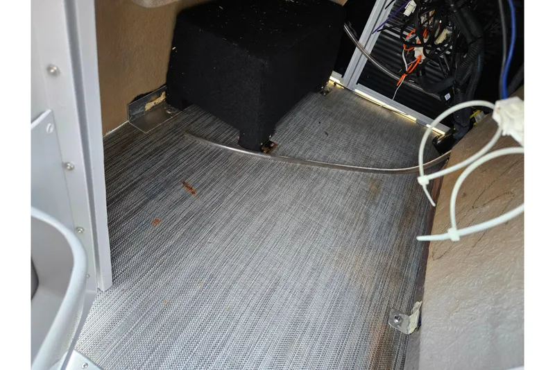 Slide: The Image of Interior view of 2021 Bennington L 22 Quad Bench boat wiring and flooring. - 22