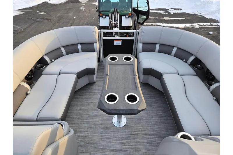 Slide: The Image of 2021 Bennington L 22 Quad Bench pontoon boat interior with gray seating and table. - 23