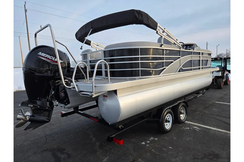 Slide: The Image of 2021 Bennington L 22 Quad Bench pontoon boat with Mercury engine on trailer. - 3