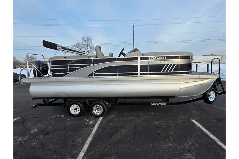 Slide: The Image of 2021 Bennington L 22 Quad Bench pontoon boat on trailer in parking lot. - 5