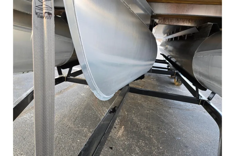 Slide: The Image of Underneath view of a 2021 Bennington L 22 Quad Bench pontoon boat on a trailer. - 8