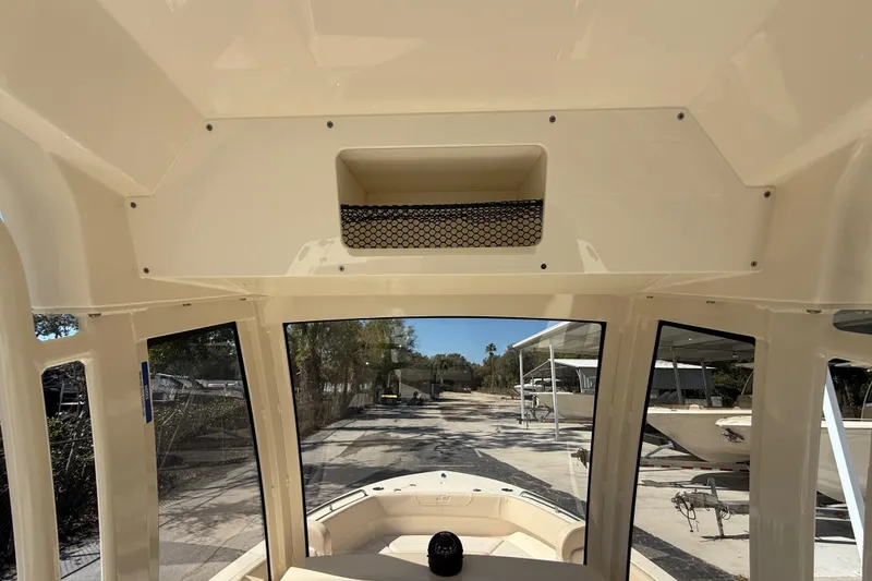 Slide: The Image of Interior view of 2026 Scout 220 XSF boat, showcasing helm and windshield. - 11