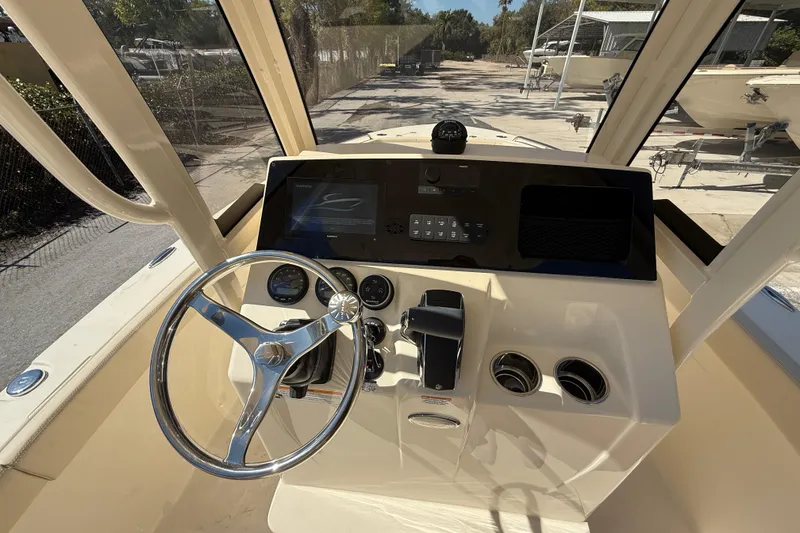 Slide: The Image of 2026 Scout 220 XSF boat dashboard with steering wheel and control panel. - 12