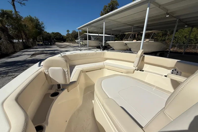 Slide: The Image of 2026 Scout 220 XSF boat interior with beige seating under a canopy. - 15