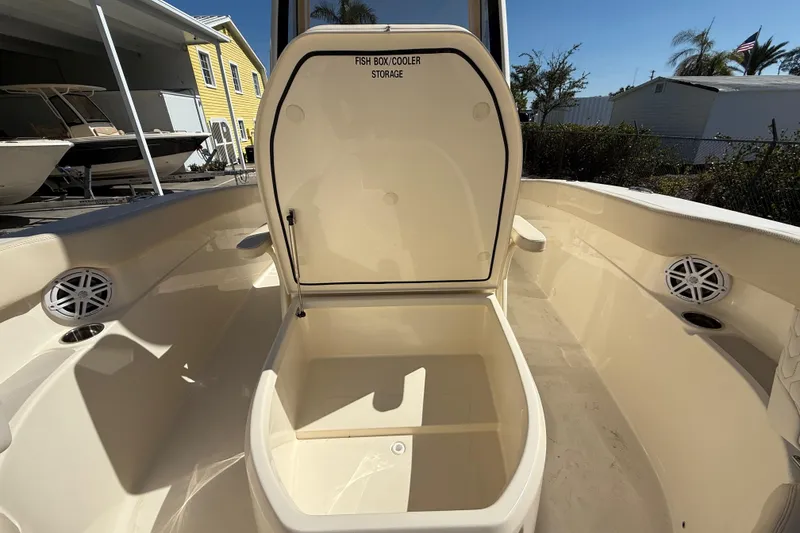 Slide: The Image of 2026 Scout 220 XSF boat with open fish box cooler storage on deck. - 18