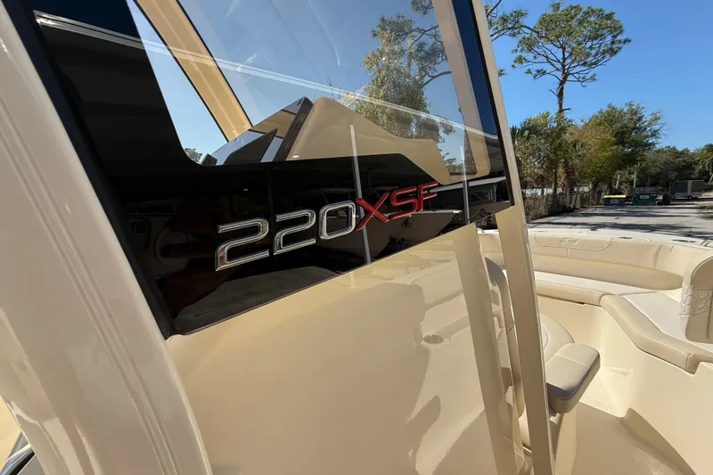 Slide: The Image of 2026 Scout 220 XSF boat interior with model branding, featuring sleek design and seating. - 20