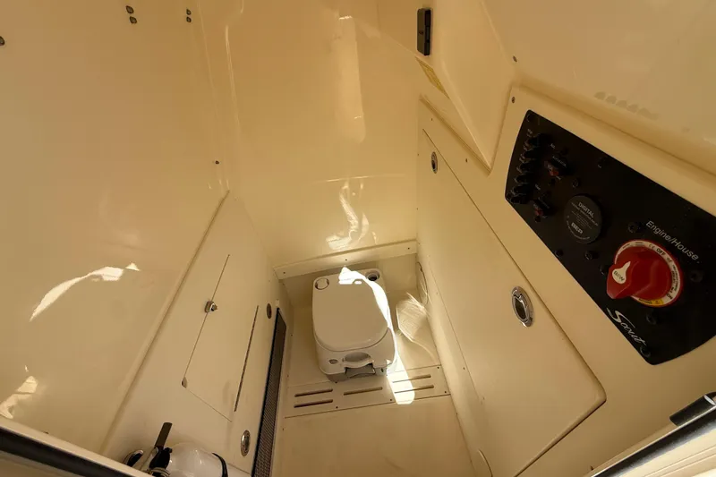 Slide: The Image of 2026 Scout 220 XSF boat interior with toilet and control panel. - 21