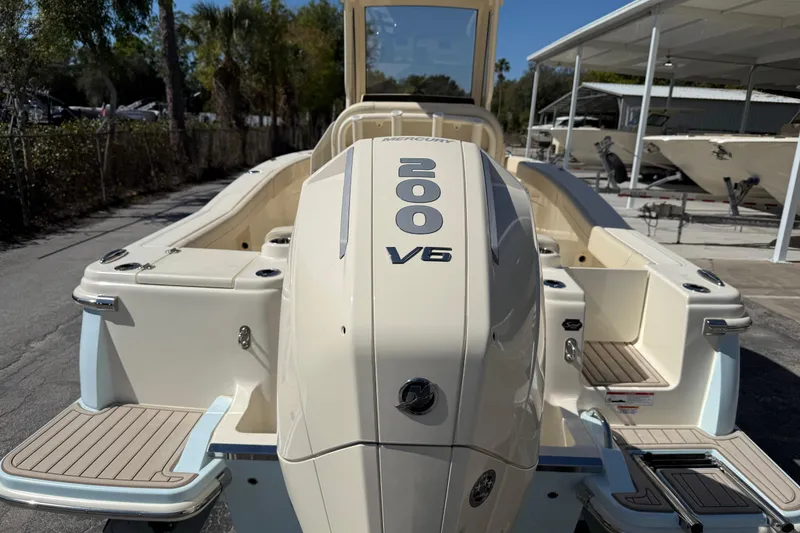 Slide: The Image of 2026 Scout 220 XSF boat with Mercury 200 V6 engine, docked outdoors. - 4