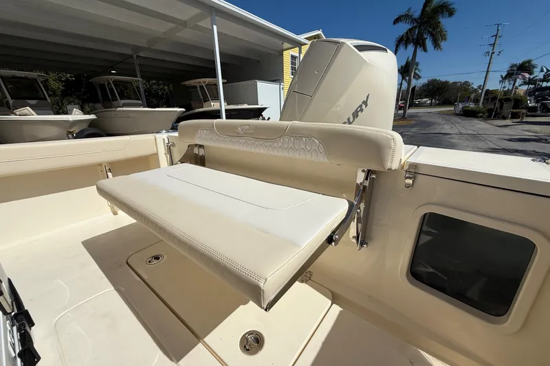 Slide: The Image of 2026 Scout 220 XSF boat interior with foldable seat and Mercury engine. - 5