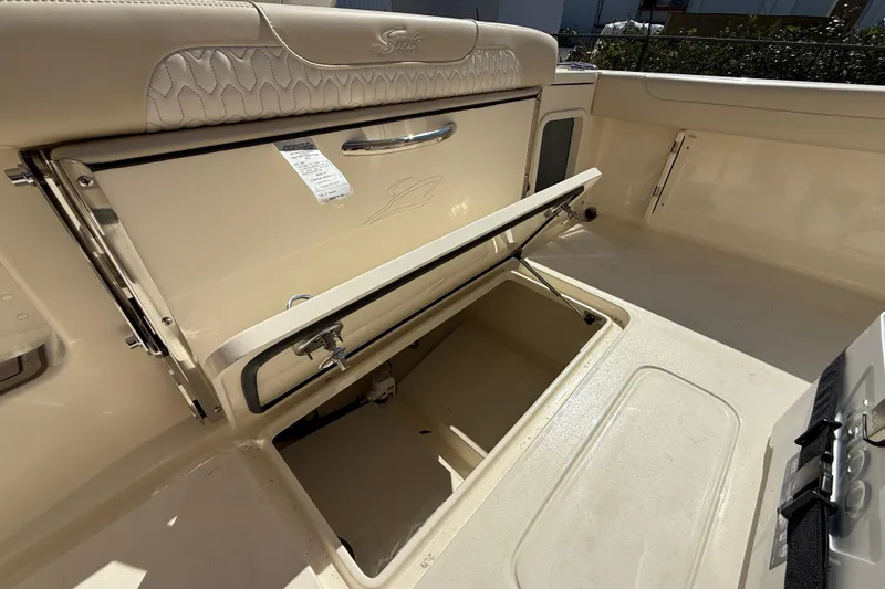 Slide: The Image of 2026 Scout 220 XSF boat interior with open storage compartment. - 6