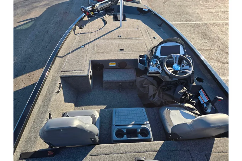 Slide: The Image of 2021 Lowe Stinger 175C boat interior with steering console and seating. - 11