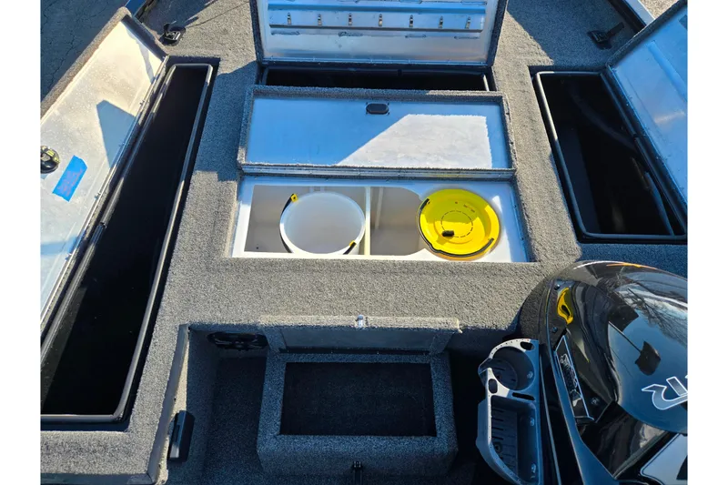 Slide: The Image of 2021 Lowe Stinger 175C boat interior with storage compartments and fishing gear. - 15