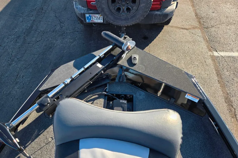 Slide: The Image of 2021 Lowe Stinger 175C boat parked, showing bow and trolling motor. - 16