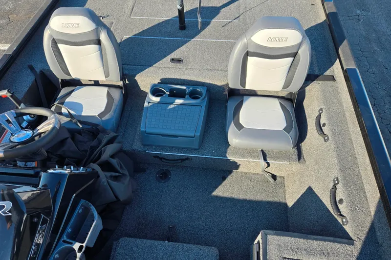 Slide: The Image of 2021 Lowe Stinger 175C boat interior with two seats and a central console. - 19