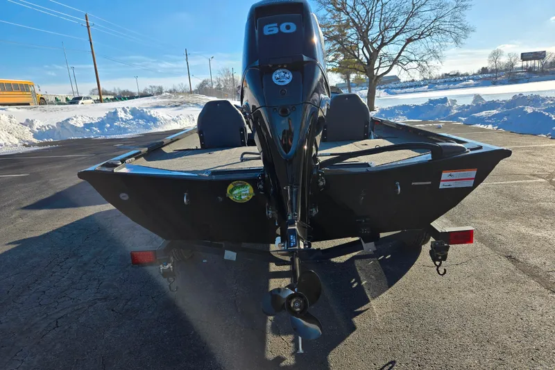 Slide: The Image of 2021 Lowe Stinger 175C boat with 60 HP motor, parked on snowy pavement. - 2