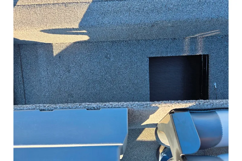 Slide: The Image of 2021 Lowe Stinger 175C boat interior with carpeted flooring and storage compartment. - 20