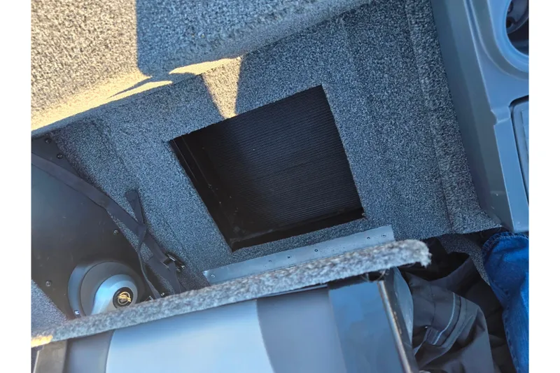 Slide: The Image of 2021 Lowe Stinger 175C boat interior with open storage compartment. - 21