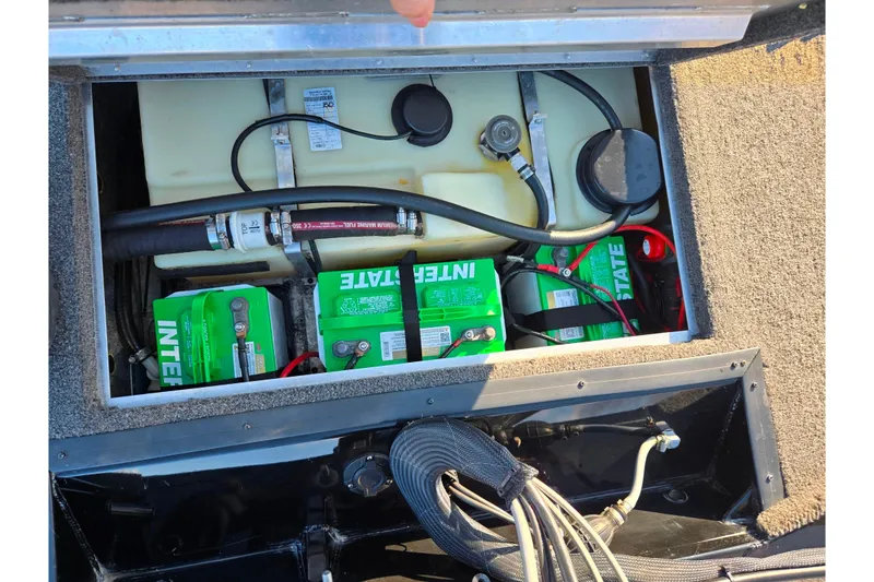 Slide: The Image of 2021 Lowe Stinger 175C boat battery compartment with Interstate batteries and fuel tank. - 23