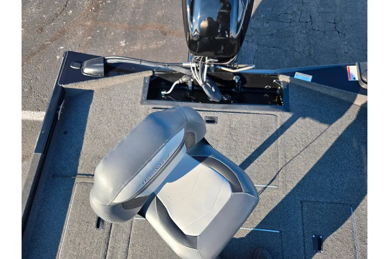 Slide: The Image of 2021 Lowe Stinger 175C boat interior with gray seating and motor. - 24