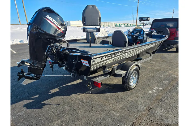Slide: The Image of 2021 Lowe Stinger 175C boat with Mercury engine on trailer in snowy parking lot. - 3