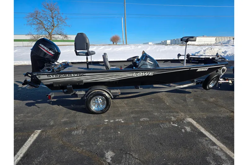 Slide: The Image of 2021 Lowe Stinger 175C fishing boat on trailer, parked on snowy pavement. - 4