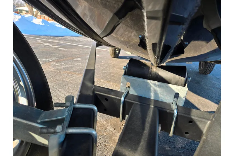 Slide: The Image of 2021 Lowe Stinger 175C boat trailer close-up, showing roller and support structure. - 7