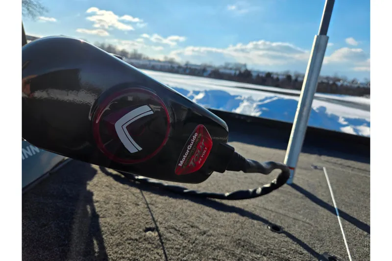 Slide: The Image of 2021 Lowe Stinger 175C boat with MotorGuide trolling motor, snowy landscape background. - 8