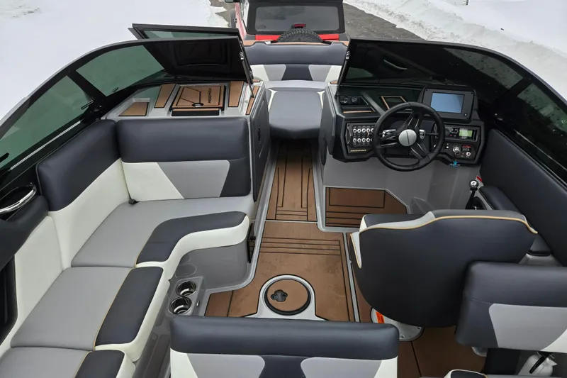 Slide: The Image of 2021 Moomba Max boat interior with modern dashboard, seating, and wood accents. - 11