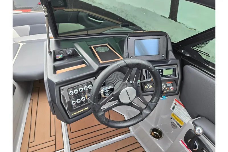 Slide: The Image of 2021 Moomba Max boat dashboard with steering wheel and control panel. - 13