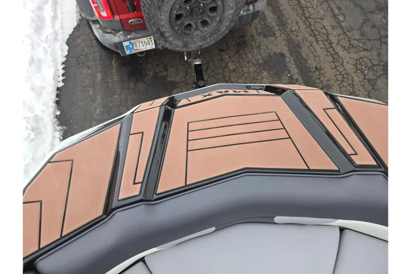 Slide: The Image of 2021 Moomba Max boat on trailer, parked on snowy pavement. - 20