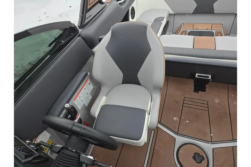 Slide: The Image of 2021 Moomba Max boat interior with steering wheel and seating area. - 23