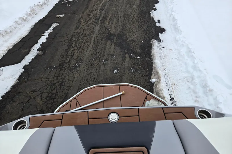 Slide: The Image of 2021 Moomba Max boat on snowy road, rear view with wooden deck. - 27