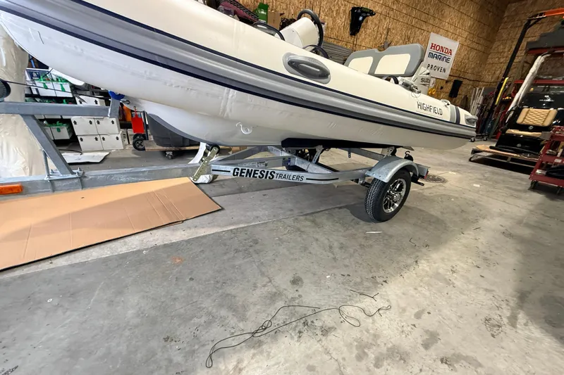 Slide: The Image of 2026 Highfield Classic 340 FCT boat on Genesis trailer in a workshop setting. - 9