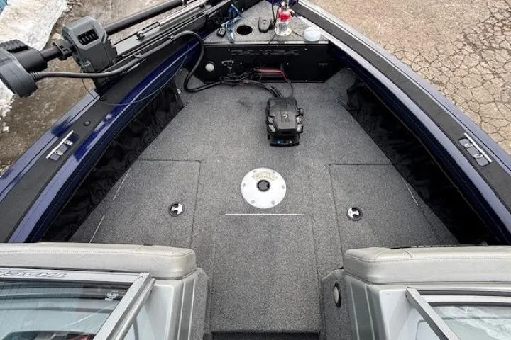 Slide: The Image of 2019 Tracker Targa V-18 Combo boat interior with carpeted deck and storage compartments. - 11