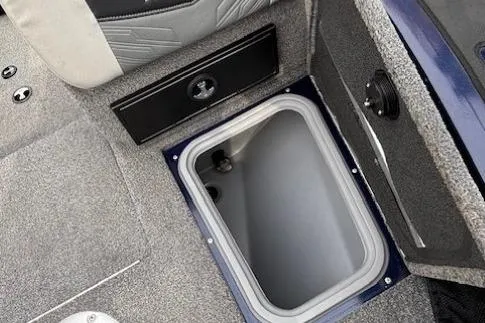 Slide: The Image of 2019 Tracker Targa V-18 Combo boat storage compartment with gray interior. - 13