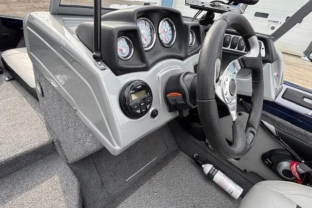 Slide: The Image of 2019 Tracker Targa V-18 Combo boat dashboard with steering wheel and gauges. - 17