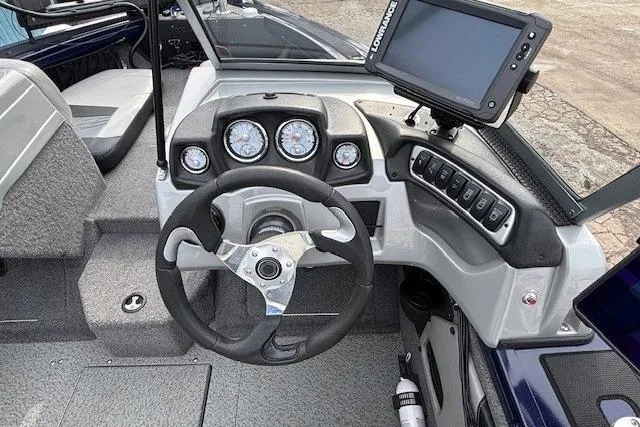 Slide: The Image of 2019 Tracker Targa V-18 Combo boat dashboard with steering wheel and navigation system. - 18