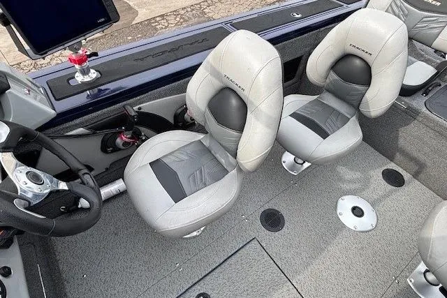 Slide: The Image of 2019 Tracker Targa V-18 Combo boat interior with gray seating and steering wheel. - 22