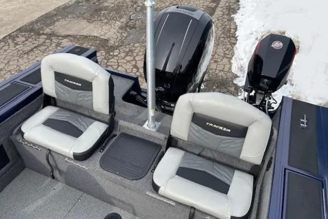 Slide: The Image of 2019 Tracker Targa V-18 Combo boat seats and motor on a snowy dock. - 31