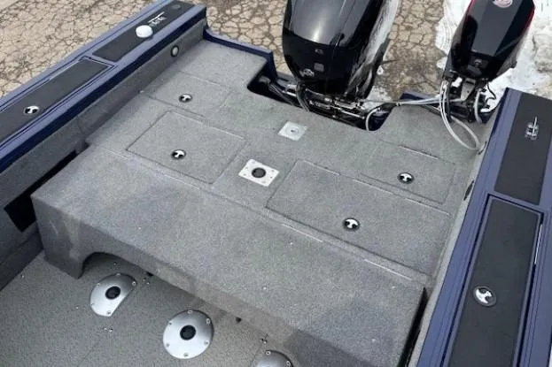 Slide: The Image of 2019 Tracker Targa V-18 Combo boat deck with dual engines and storage compartments. - 32