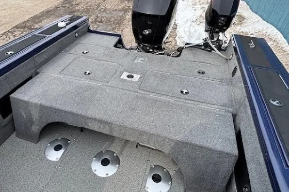 Slide: The Image of 2019 Tracker Targa V-18 Combo boat interior with dual engines and storage compartments. - 33