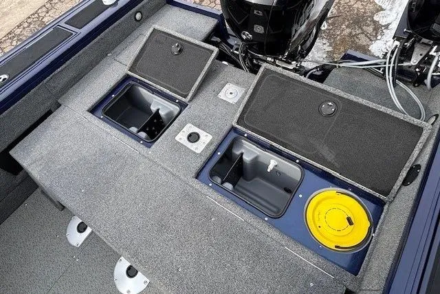 Slide: The Image of 2019 Tracker Targa V-18 Combo boat interior with storage compartments and motor. - 36