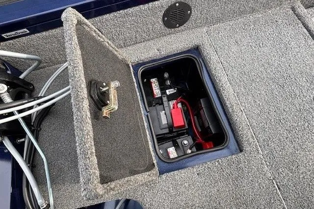 Slide: The Image of 2019 Tracker Targa V-18 Combo boat battery compartment with open hatch. - 37