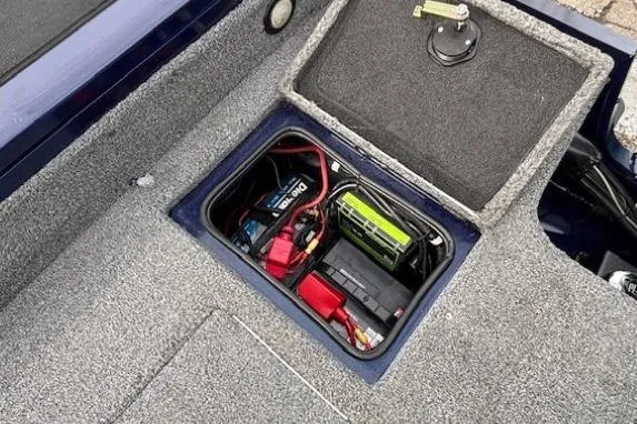 Slide: The Image of 2019 Tracker Targa V-18 Combo boat battery compartment with wiring and storage. - 38