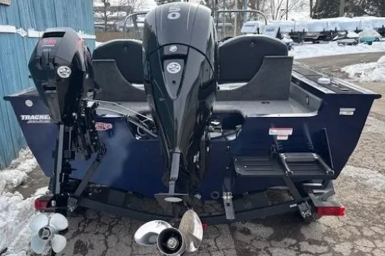 Slide: The Image of 2019 Tracker Targa V-18 Combo boat with dual outboard motors, parked on snowy pavement. - 4